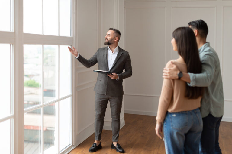 Real Estate Agent Showing Young Buyers New Property